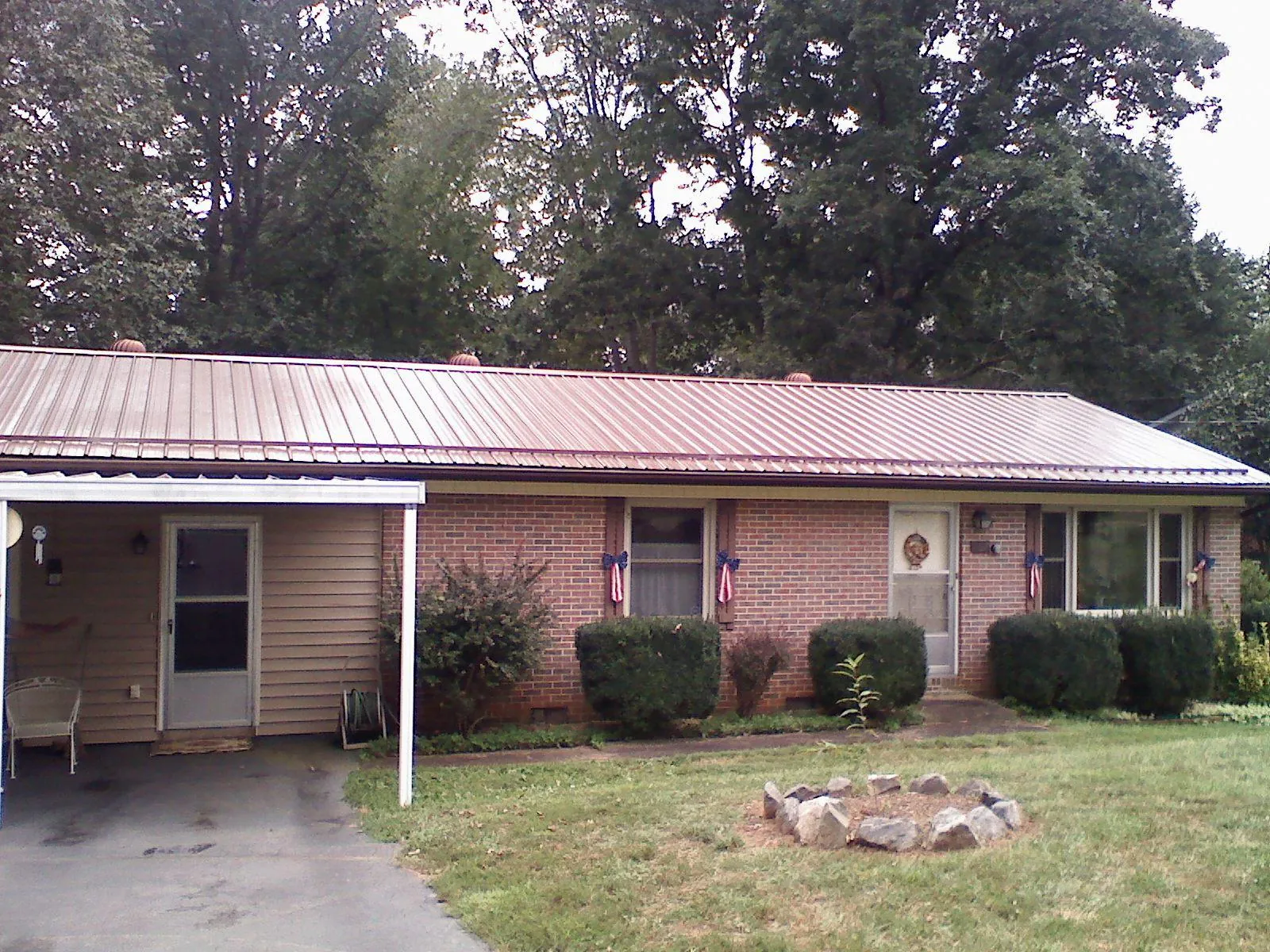 Bronze metal roof and carport on a brick ranch home — Roof Repair work by our crew in Connelly Springs
